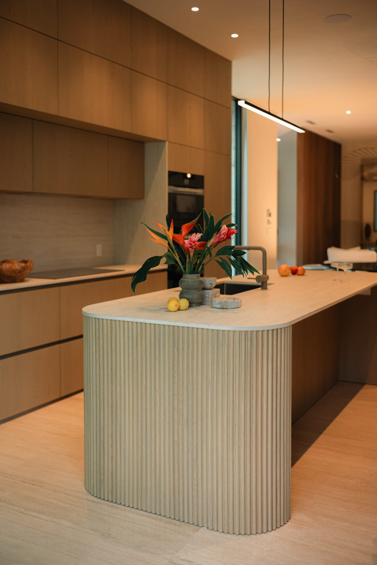 Bright kitchen with oak cabinetry and a fluted island