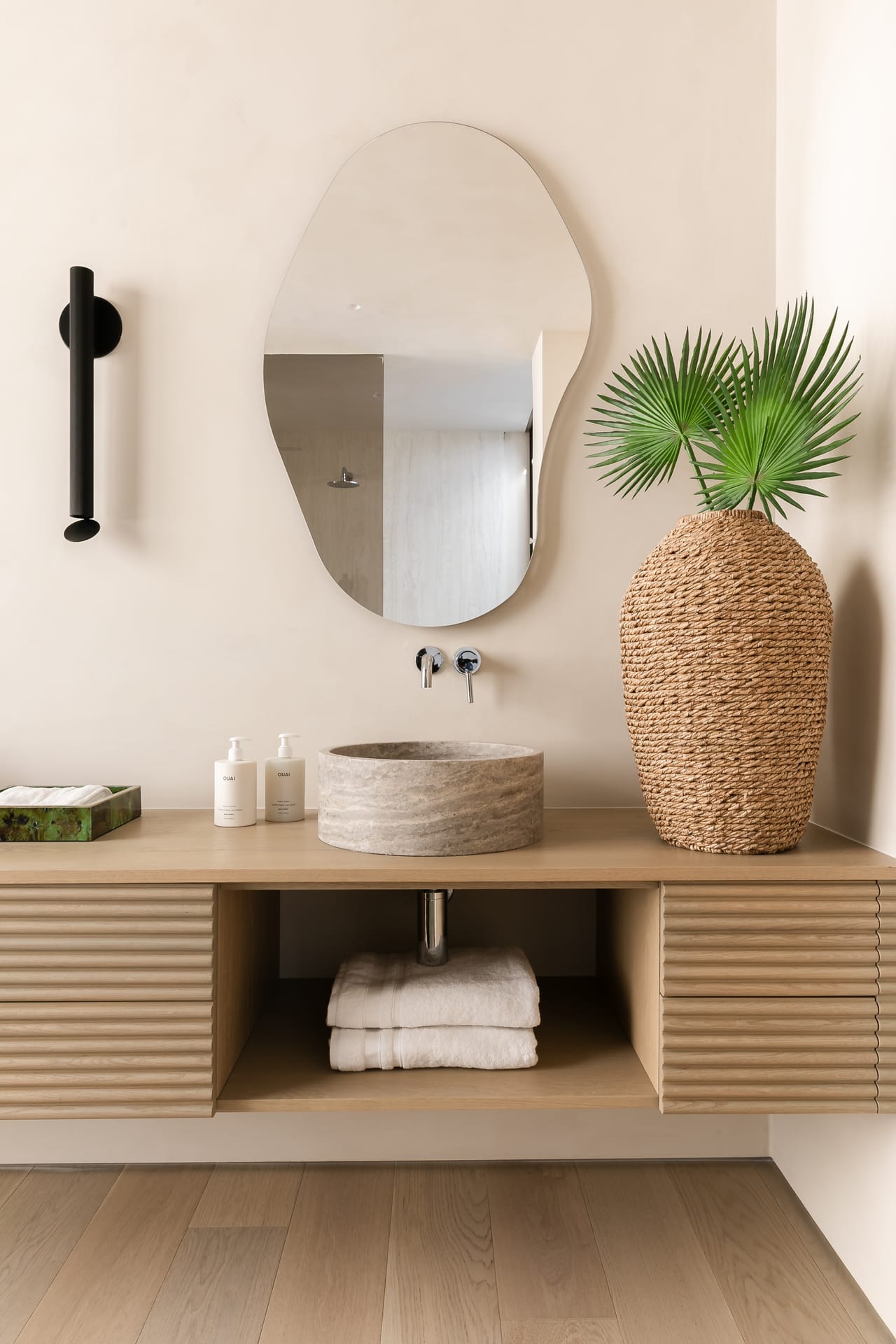 Double vanity in reeded oak with organic mirrors and stone vessel basins