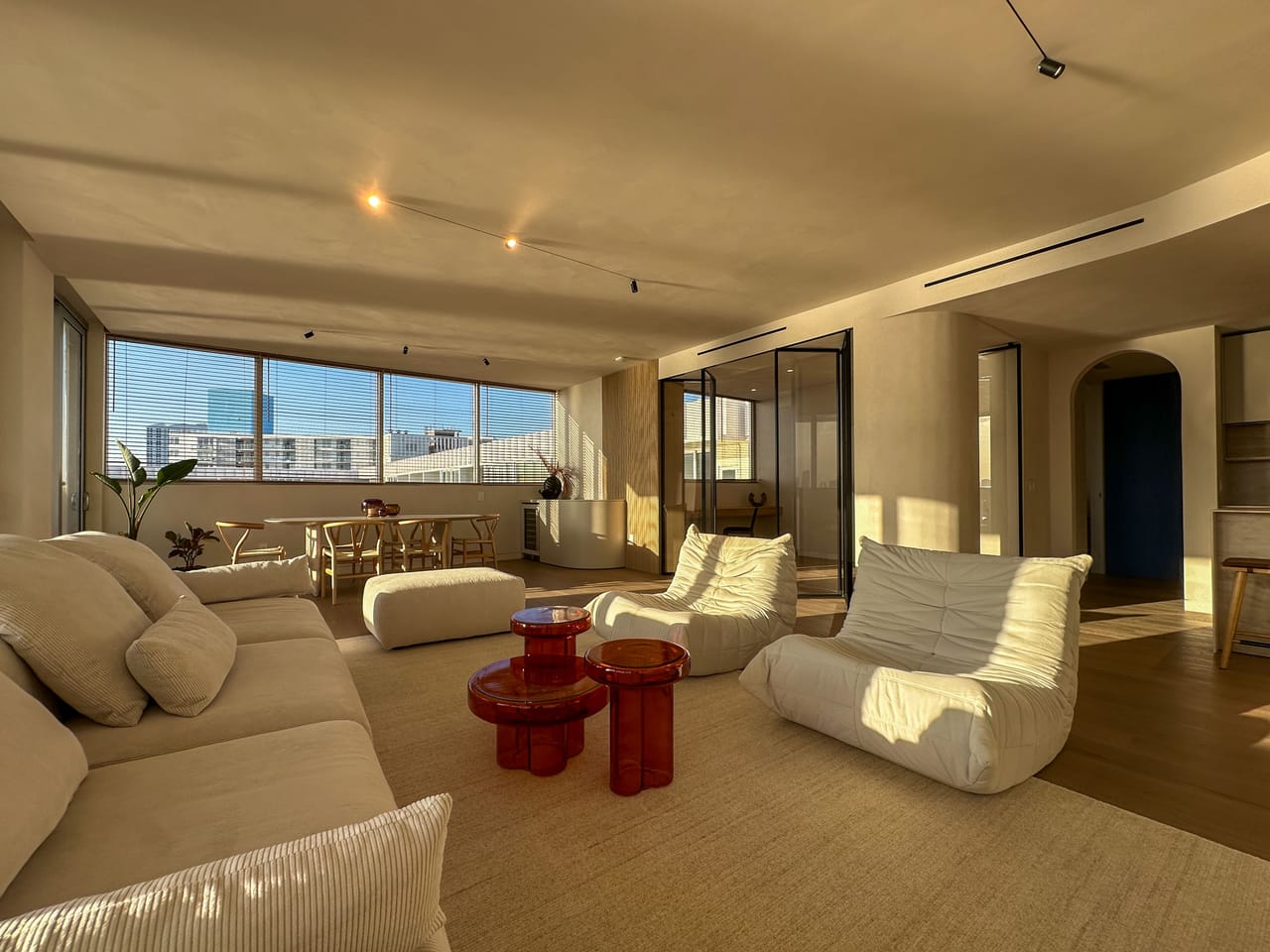 Golden-hour living room with modular sofas and open bay views