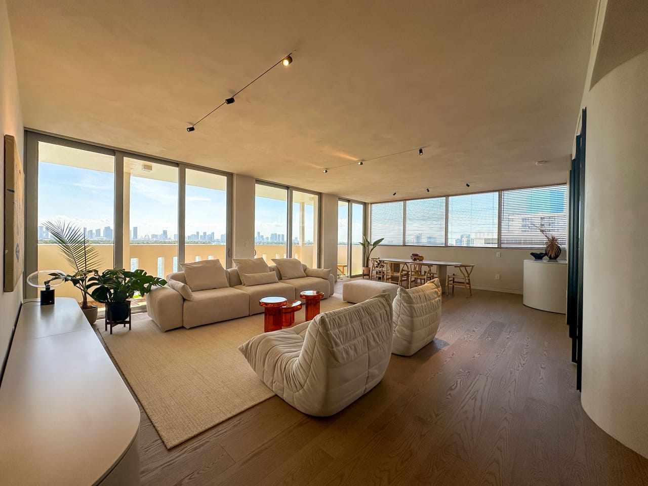 Living room with a curved architectural ceiling and the skyline beyond