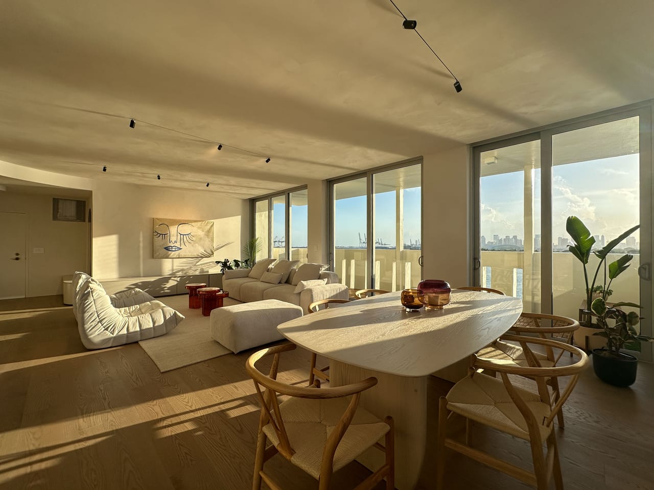 Dining and living space in warm evening light over the water
