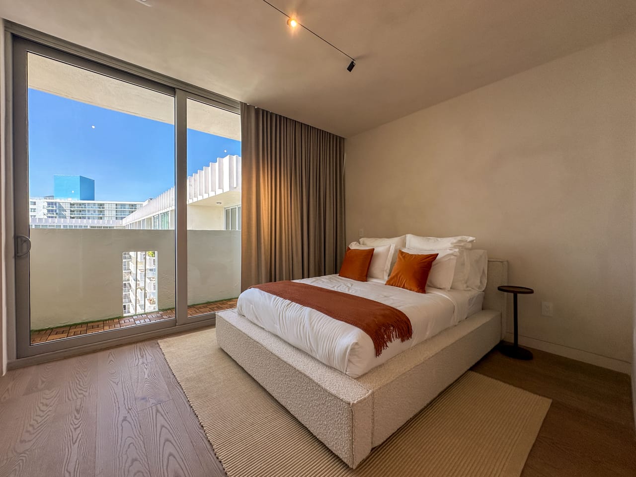 Bedroom with floor-to-ceiling glass and a terrace outlook